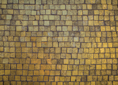 Texture of old gold stone tiles. Gold background