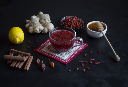 Tea with fresh Goji berries, lemon, honey and gingerの写真素材