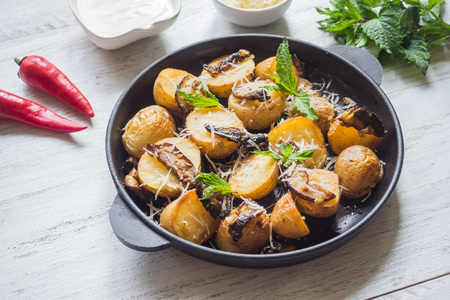 Rustic potatoes with mushrooms on a white wooden table. Top viewの写真素材