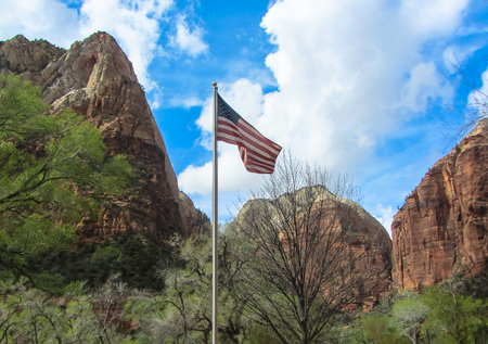 American flag on a mountain and cloudy sky backgroundの写真素材