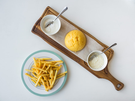 Romanian corn porridge Mamalyga with cheese and sour cream on a wooden standの写真素材