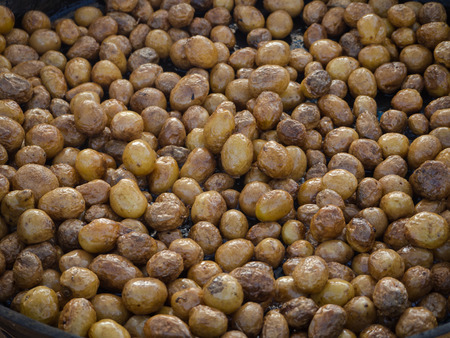 Barbecue cooking. A whole small young potatoes fried in a large pan