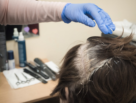 The process of hair coloring in beauty salon. Close upの写真素材