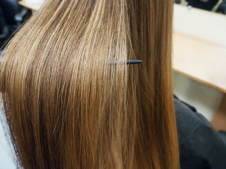 A strand of hair after the straightening procedure.の写真素材