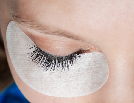 Combing your eyelashes. Close up. Cosmetic procedure for the care of eyelashes.