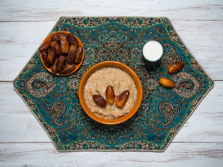Healthy eating, healthy breakfast food. Oatmeal porridge with dates and milk.の写真素材