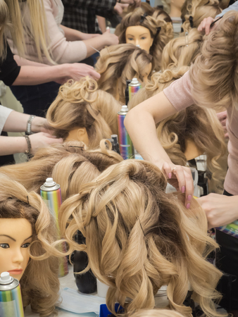 Training hairstyles on the mannequin. Teamwork. Close upの写真素材