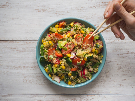 Salad with quinoa hand eating chopsticks. Top view.の写真素材