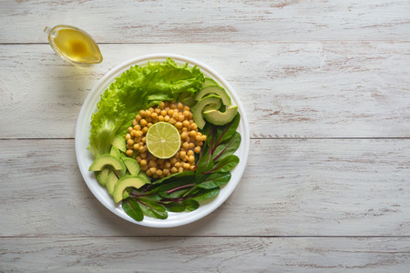Fresh organic chickpeas and avocado salad flat lay on a plate.の写真素材