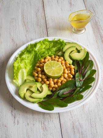 Fresh organic chickpeas and avocado salad flat lay on a plate.の写真素材