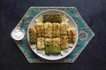 Arabic food. Appetizing cabbage rolls tied with white sauce. Top view.
