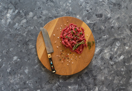 Fresh meat cut into thin strips on a cutting board.の写真素材