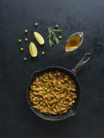 Asian beef thin slices with green peas in curry sauce.の写真素材