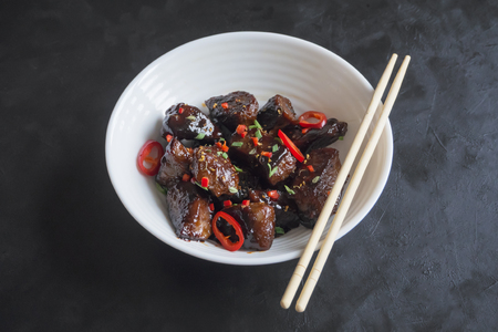 Chinese Beef with honey and black pepper sauce on a black table.の写真素材