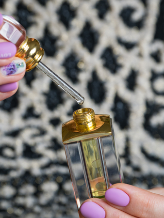 Arabian oud attar essential or agarwood oil fragrances in glass bottles.