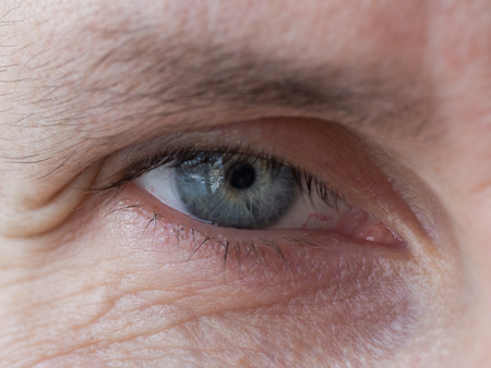 Wrinkles in the eyes of a man of age. Close up