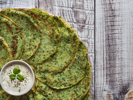 Gluten free spinach pancakes on a wooden table