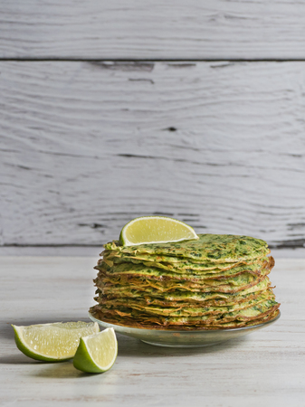 Gluten free spinach pancakes on a white tableの写真素材