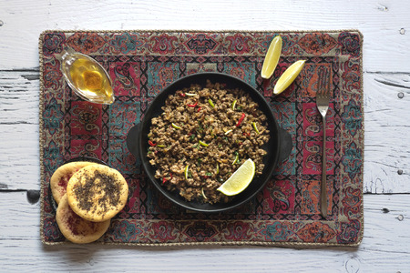 Indian minced meat Qeema on a white wooden table. Top view.の写真素材