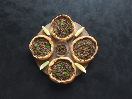 Traditional Lebanese meat pies on a black table. Top view.の写真素材
