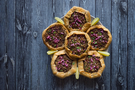 Open meat pies on dark wooden background. Top view.の写真素材
