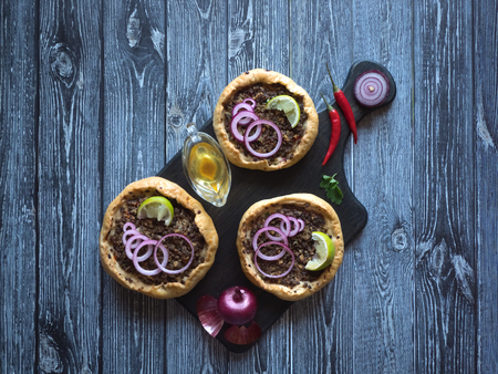 Arabian opened meat pies Sfiha on wooden cutting board. Top view.の写真素材