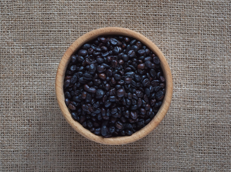 Roasted wild coffee in a wooden bowlの写真素材