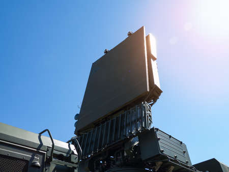 Military directional antenna on a blue sky background.