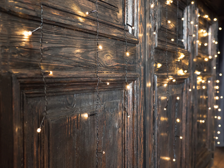 Vintage wooden wall with garlands. Wooden wall decorated by electric lamps.の写真素材