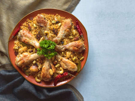 Chicken Mandi with dates on a dark table. Arabic cuisine. Top view.の写真素材