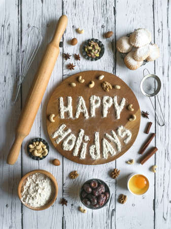 Happy holidays food background. Egg, flour and nuts are laid out on a dark background.