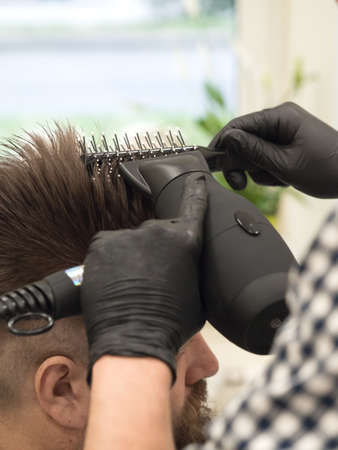 Trimming the mustache in a barbershop. Details of trimming. Cropped closeup of a barber trimming beard.の写真素材