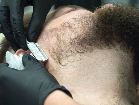 Shaving the beard in the Barber shop. Close upの写真素材