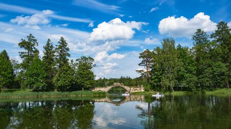Summer panoramic landscape on the lake with people in boats.の写真素材