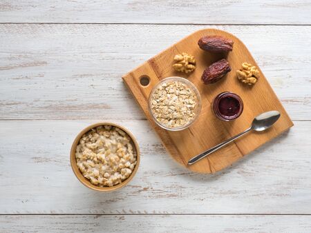 Oatmeal porridge with dates in a cardboard cup. Healthy food and diet concept.の写真素材