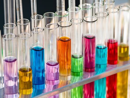 Test tubes with a colored reagents in a rack.