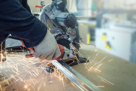 Cutting Steel channel with grinder. Sparks while grinding ironの写真素材
