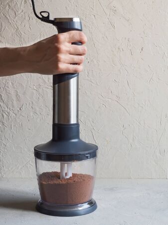 Process of grinding cacao beans in a blenderの写真素材