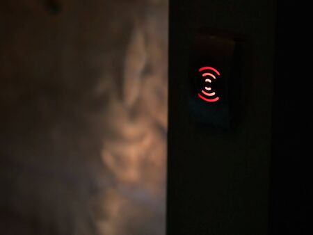The red touch button glows on a black background.