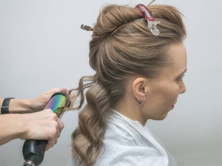 Beautiful middle aged blonde woman with long wavy hair. Hollywood hairstyle and soft make-up. Real...