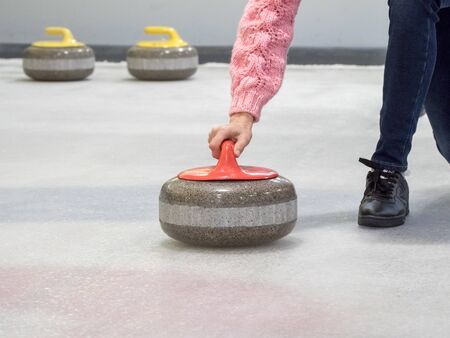 Curling stone on ice of a indoors rinkの写真素材