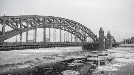 Panorama of a large metal bridge over the river in winter. Bolsheokhtinsky bridge in Saint Petersburg.の写真素材