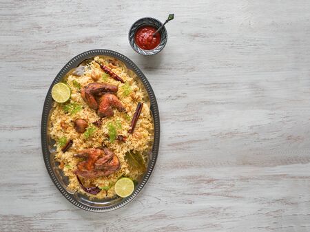 Homemade chicken Biryani. Arabic traditional food bowls Kabsa with meat. Top view, copy space.の写真素材