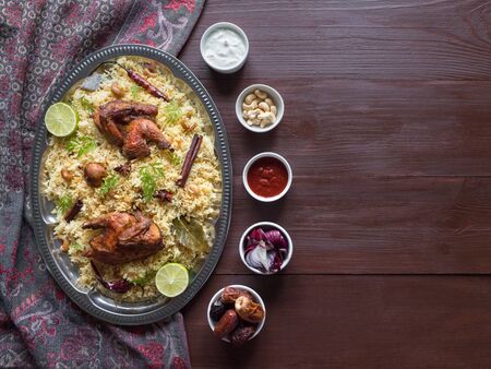 Homemade chicken Biryani. Arabic traditional food bowls Kabsa with meat. Top view, copy space. の写真素材