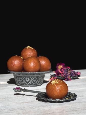 Indian traditional sweet Gulab Jamun, close up, copy space.