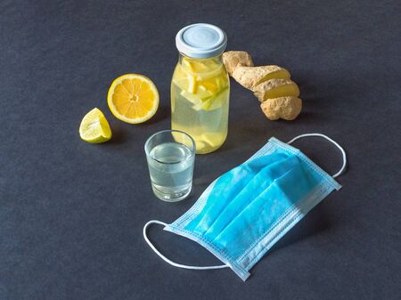 Antiviral tincture of alcohol with lemon and ginger root, strengthening of immunity concept, top view. の写真素材