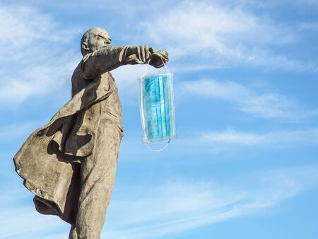 Monument of Lenin and medical mask, protection against coronavirus and other viruses.