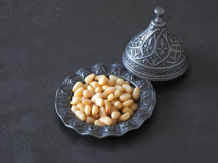 Pine nuts on the black table. Close up.の写真素材