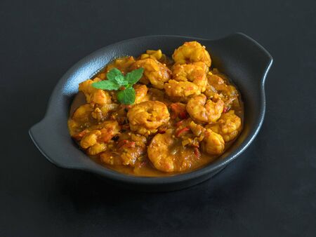 Hot spicy prawn curry. Shrimp in curry sauce in the pan.の写真素材