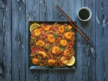 Asian udon noodles with fried shrimps, top view.の写真素材